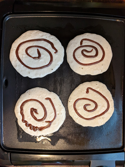 cin roll pancakes on the griddle